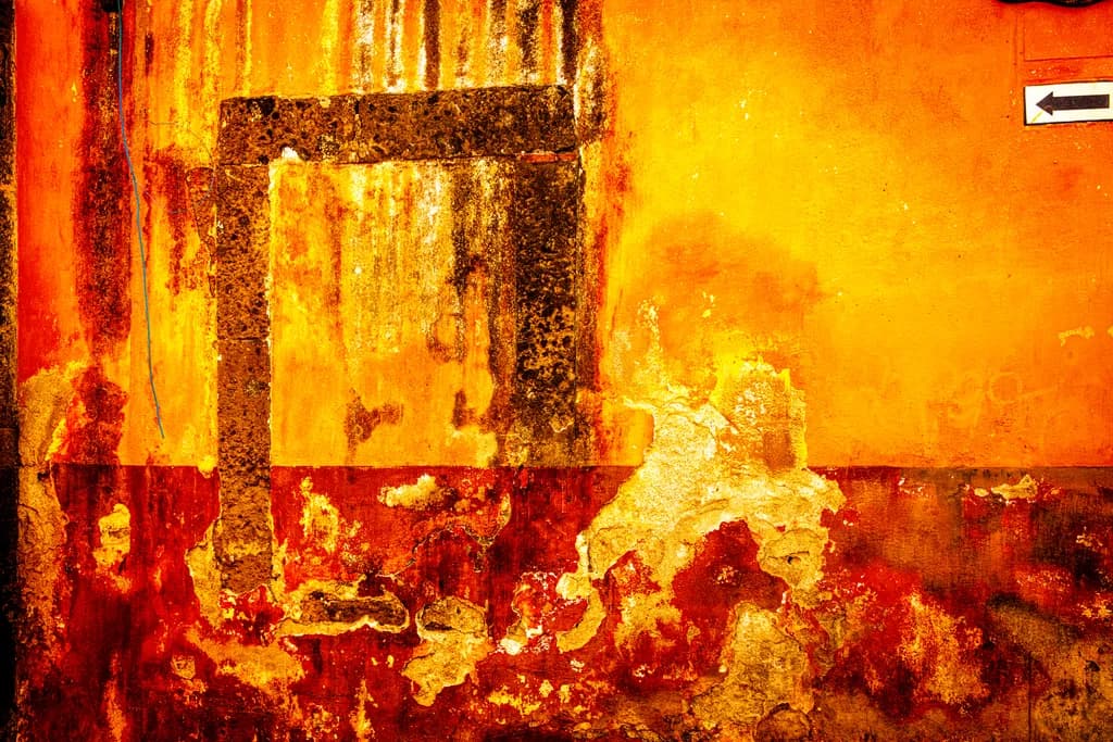 Vibrant Decay: The Art of Weathered Walls in Fiery Hues
