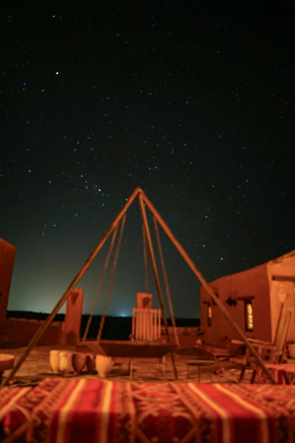 Whispers of the Desert Night: A Celestial Dance Above Ancient Dwellings