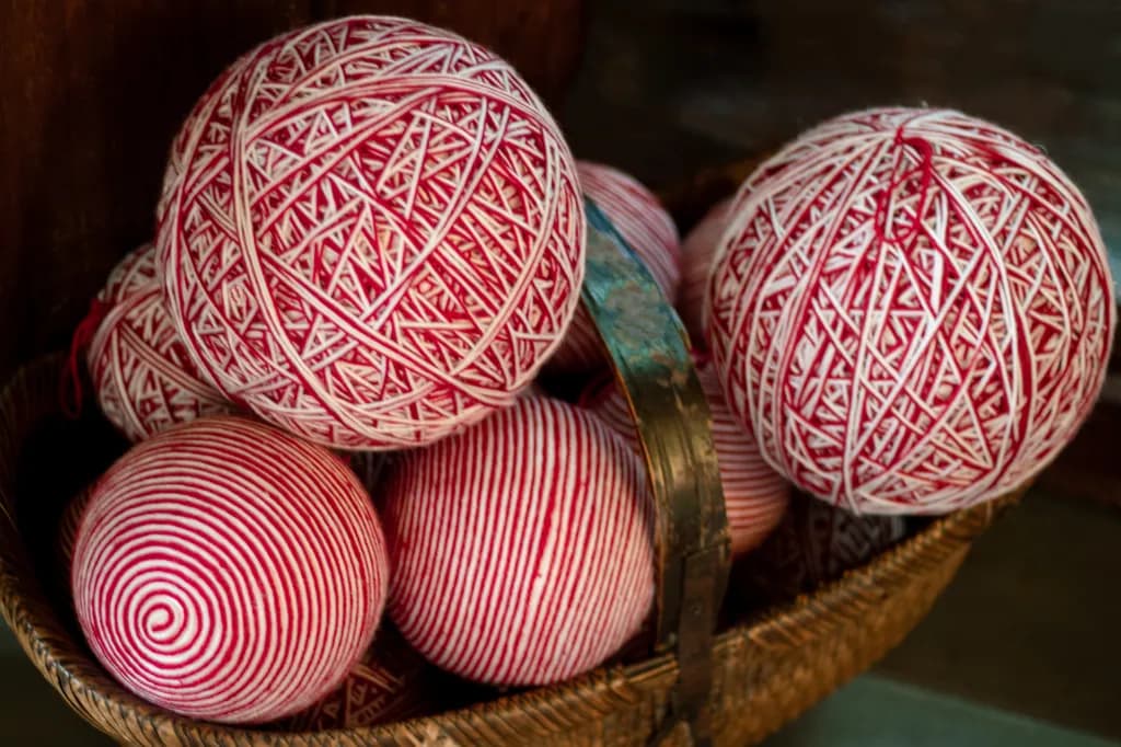 Whimsical Harmony: A Basket of Red and White Yarn Balls