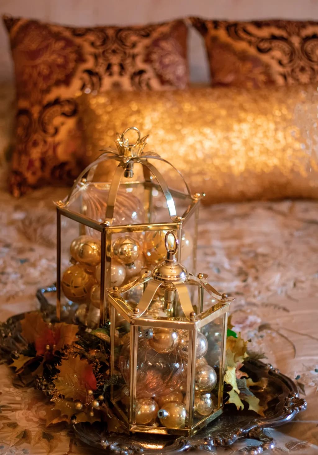 Golden Elegance: A Festive Display of Ornaments in Glass Lanterns