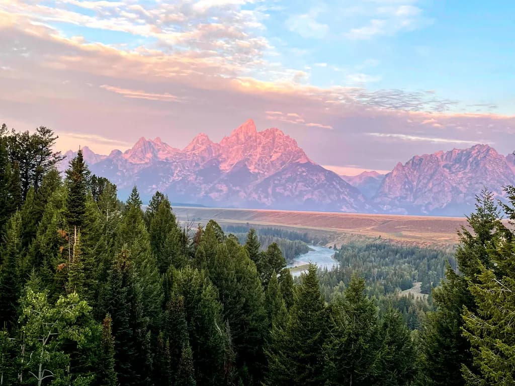 Majestic Peaks at Dusk: A Serene Landscape of the Grand Tetons and Lush Forests