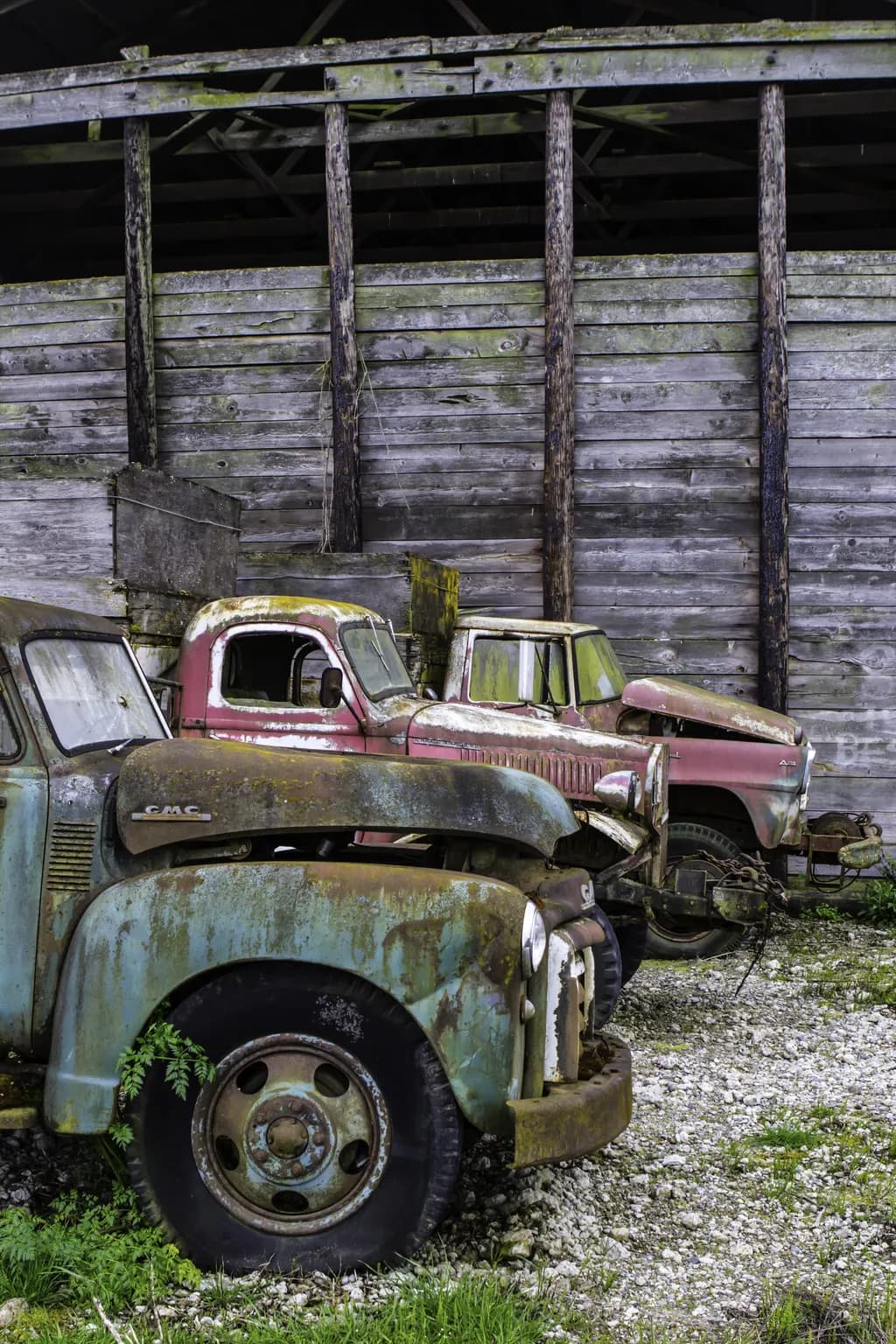 Rustic Memories: A Journey Through Time with Abandoned Trucks in a Weathered Barn