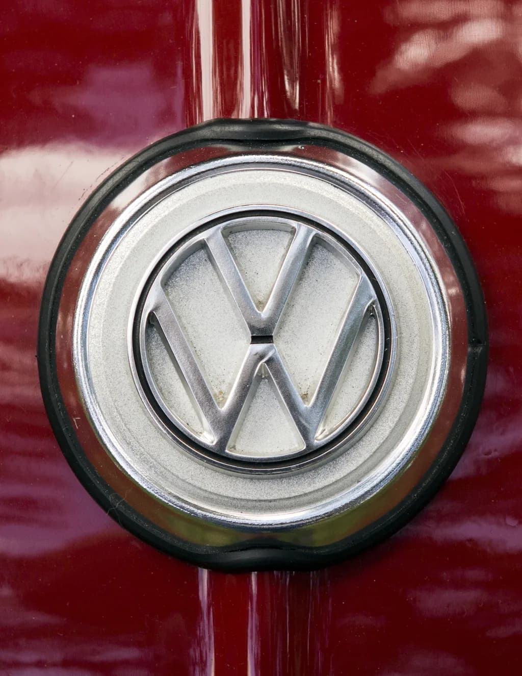 Classic Charm: The Timeless Volkswagen Emblem on a Rich Red Canvas