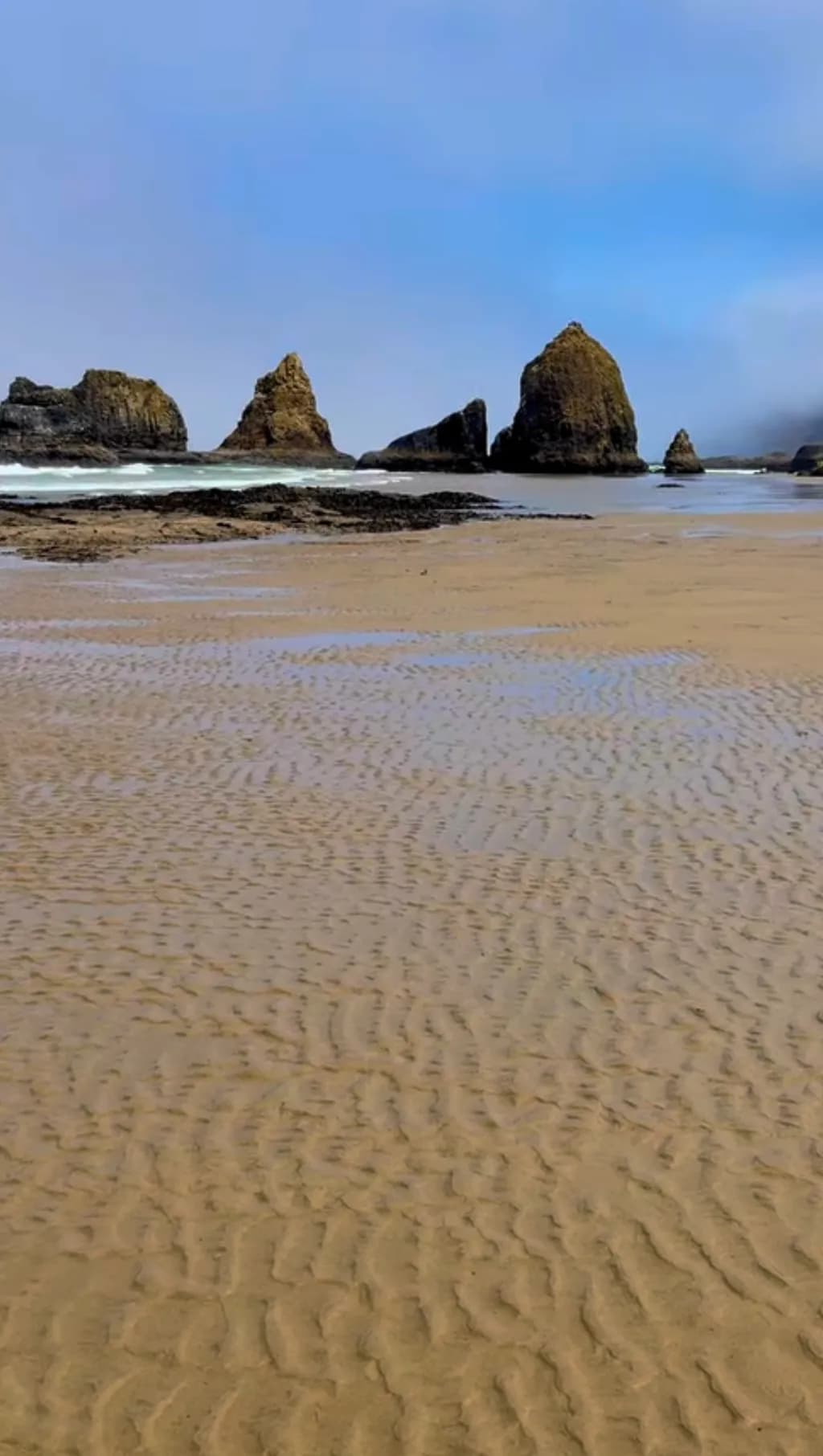 Whispers of the Shore: Tranquil Tides and Majestic Rocks at Dusk