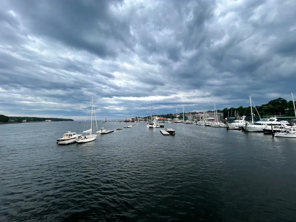 Serene Harbor: A Dance of Boats Beneath Dramatic Skies