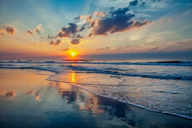Serene Sunset Reflections: A Tranquil Beachscape at Dusk