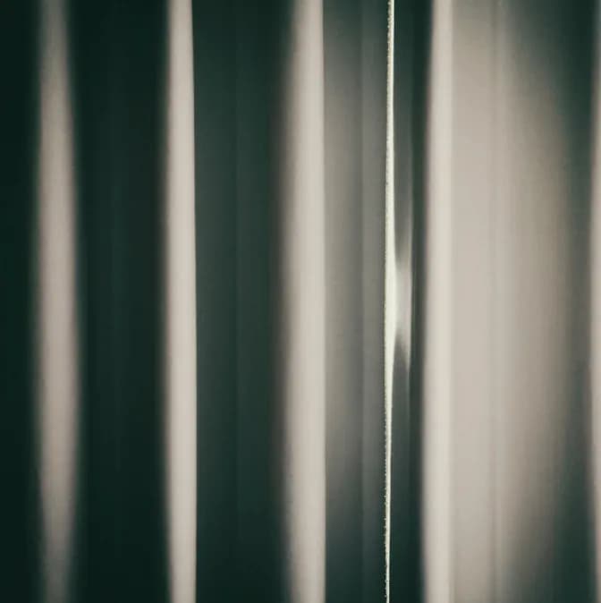 Whispers of Light: A Dance of Shadows and Textures Behind the Curtain