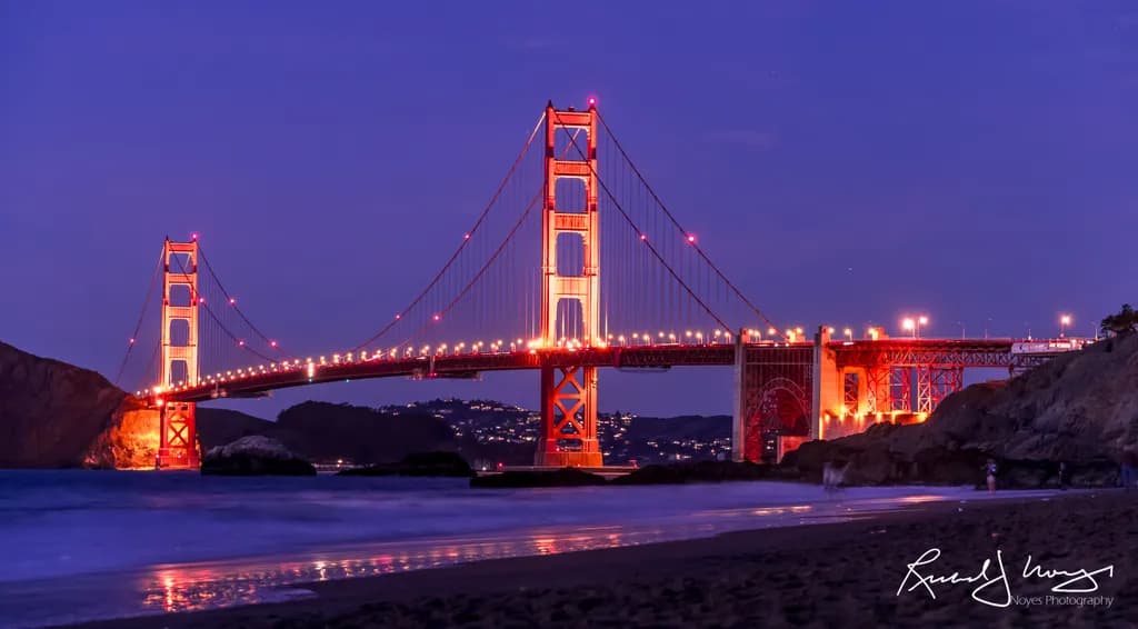 Golden Gate Bridge at Twilight: A Serene Nightscape Over Illuminated Waters