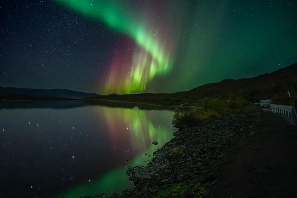 Whispers of the Aurora: A Dance of Light and Reflection in the Night Sky