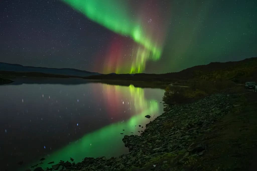 Whispers of the Aurora: A Dance of Light and Reflection in the Night Sky