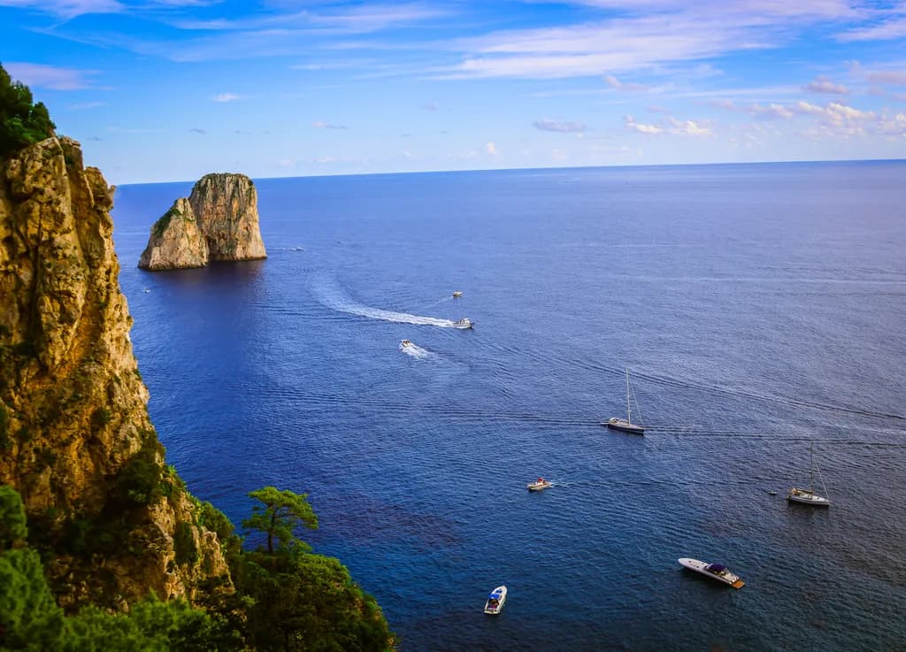 Serenity by the Sea: A Coastal Landscape of Cliffs and Boats Under a Vast Sky