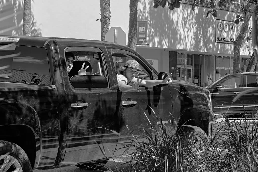 Urban Whispers: A Playful Encounter in Monochrome Streets
