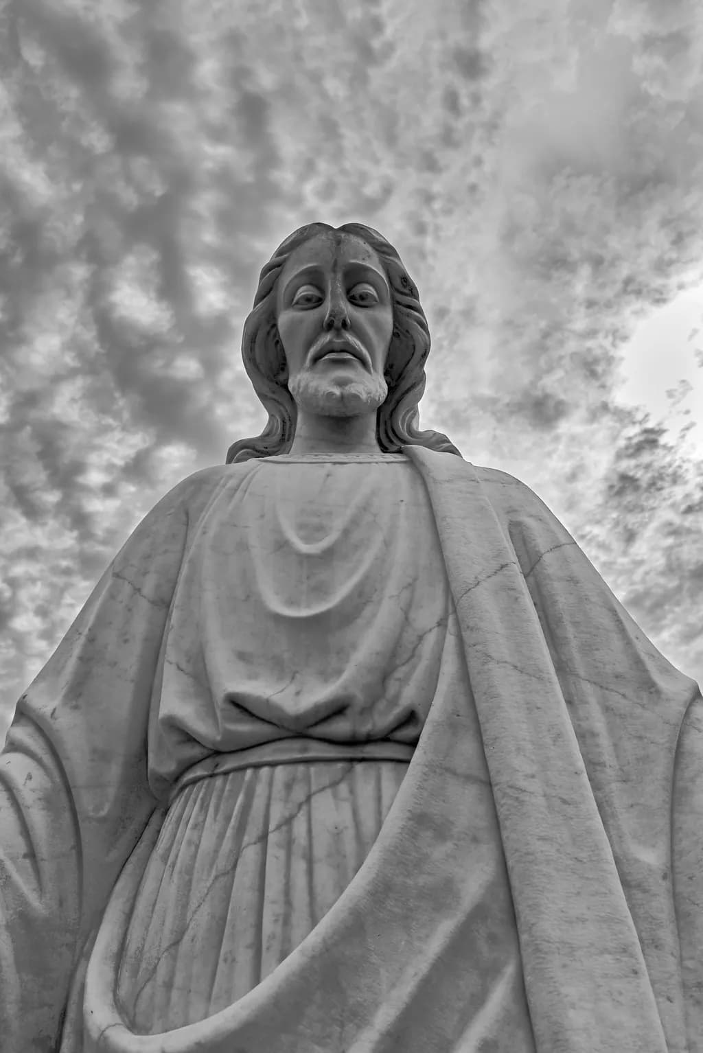 Ethereal Serenity: A Monochrome Tribute to Faith and Sculpture in the Clouds