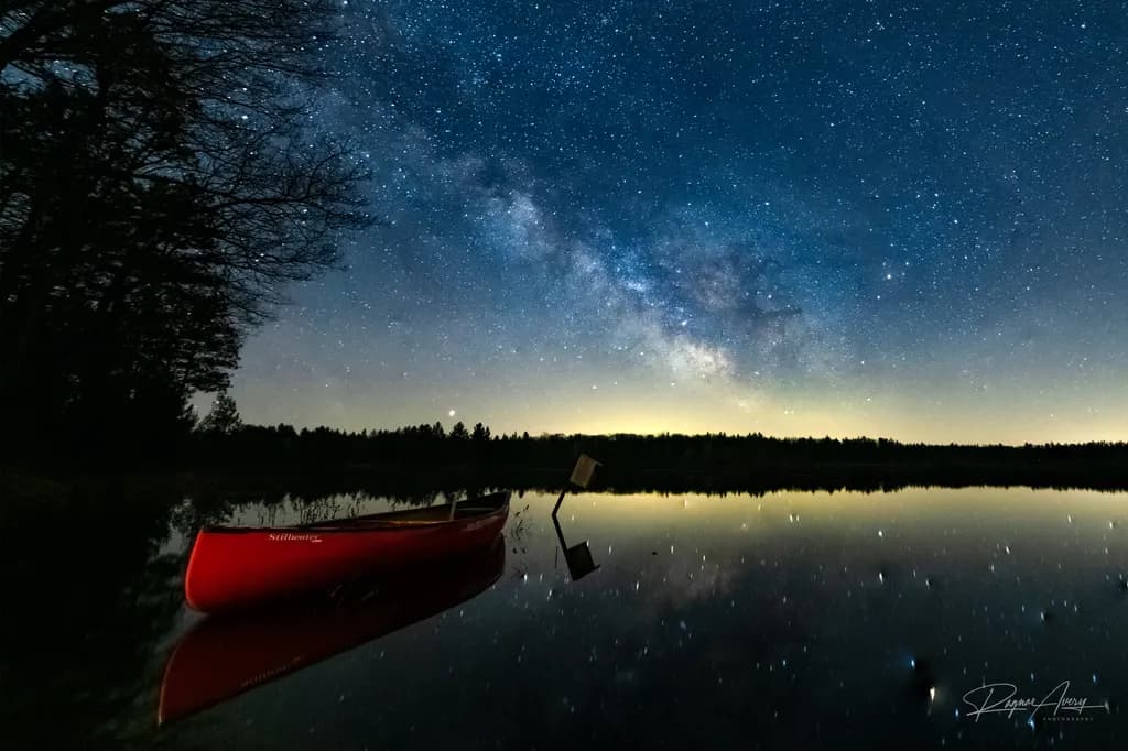 Night Sky Over Lake with Canoe