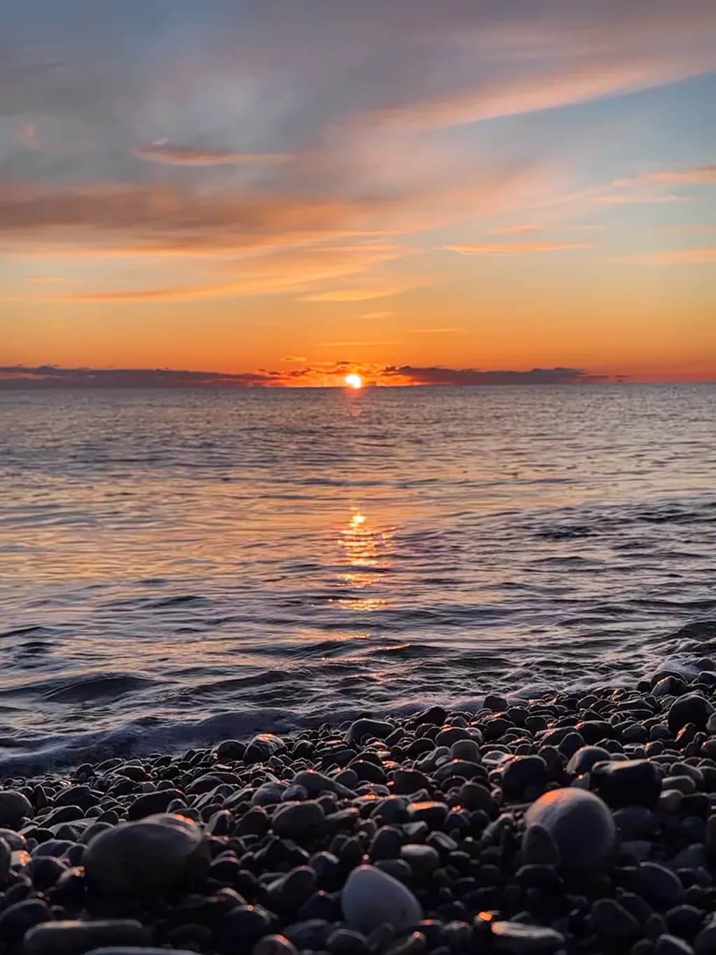 Serenity at Sunset: A Tranquil Reflection on Water and Rocks