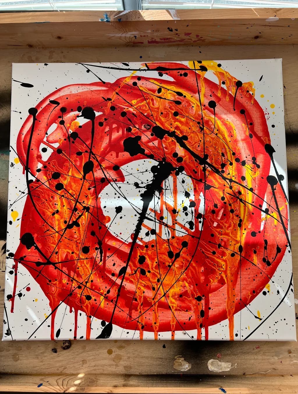 Vibrant Chaos: A Dance of Red and Black Splashes on Canvas