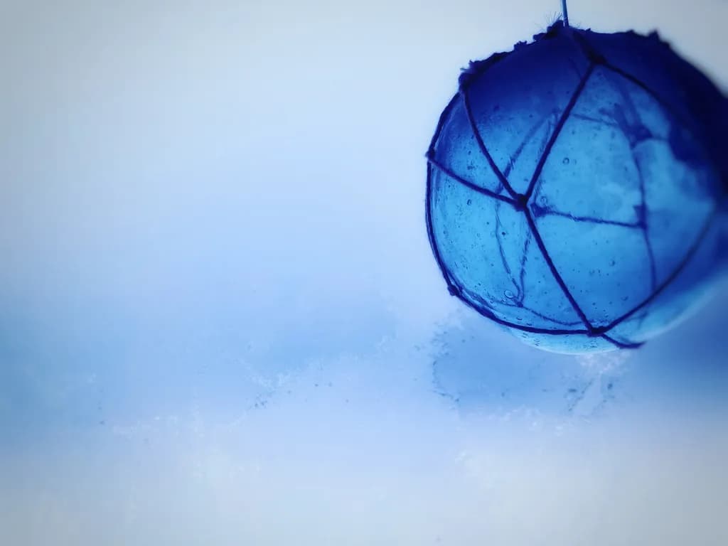 Delicate Blue Orb: A Transparent Dance of Light and Abstract Beauty