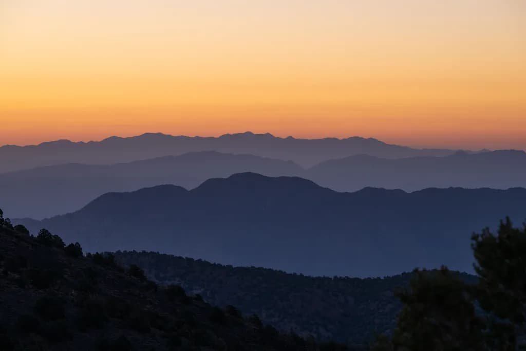 Whispers of Dusk: A Serene Sunset Over Majestic Mountains