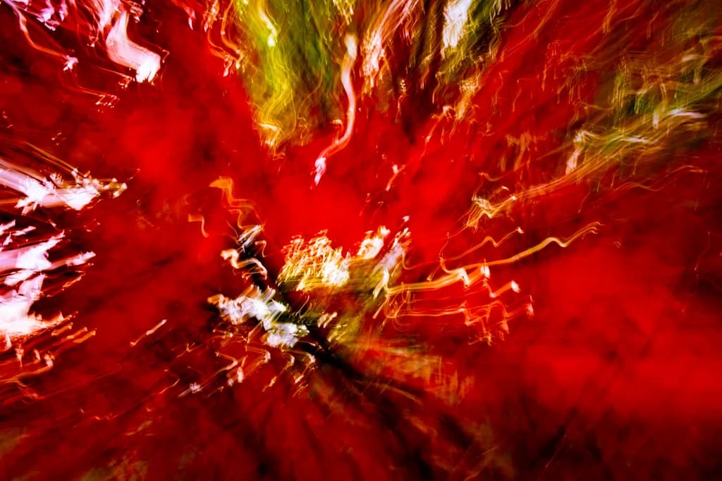 Vibrant Whirlwind: A Dance of Red and Light in Nature's Embrace