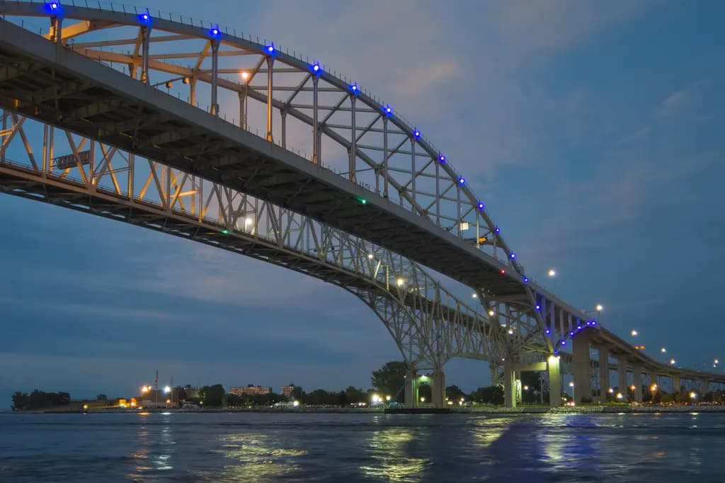 Bridging the Night: A Dance of Lights and Water Under the Stars