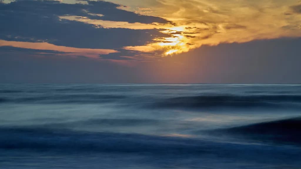 Whispers of the Ocean: A Serene Sunset Over Gentle Waves