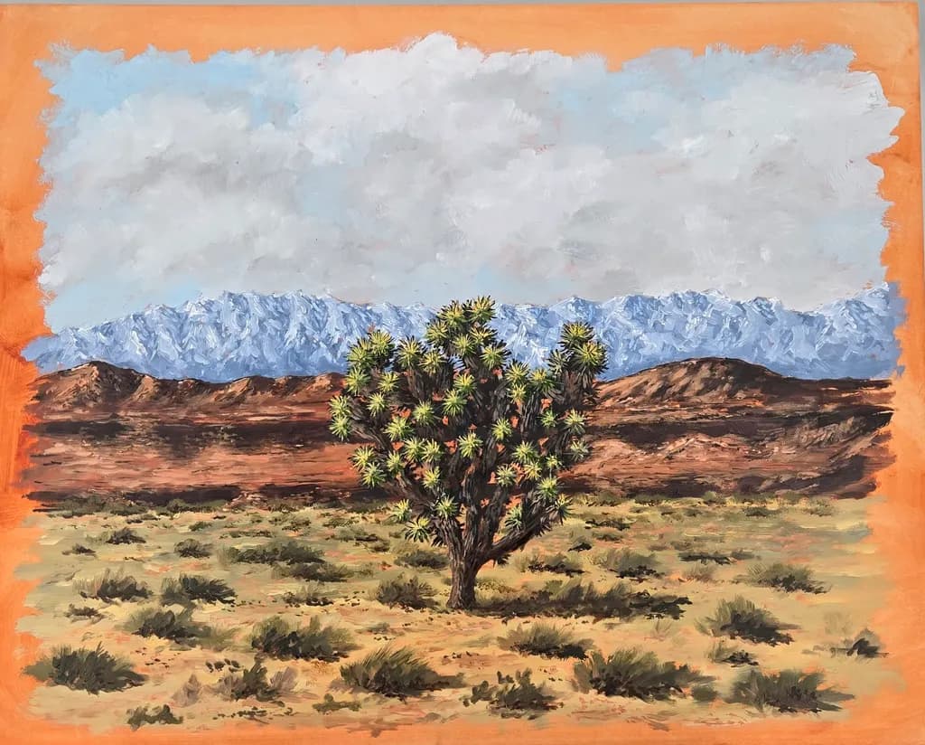 Desert Serenity: A Joshua Tree Against Majestic Mountains and Colorful Skies