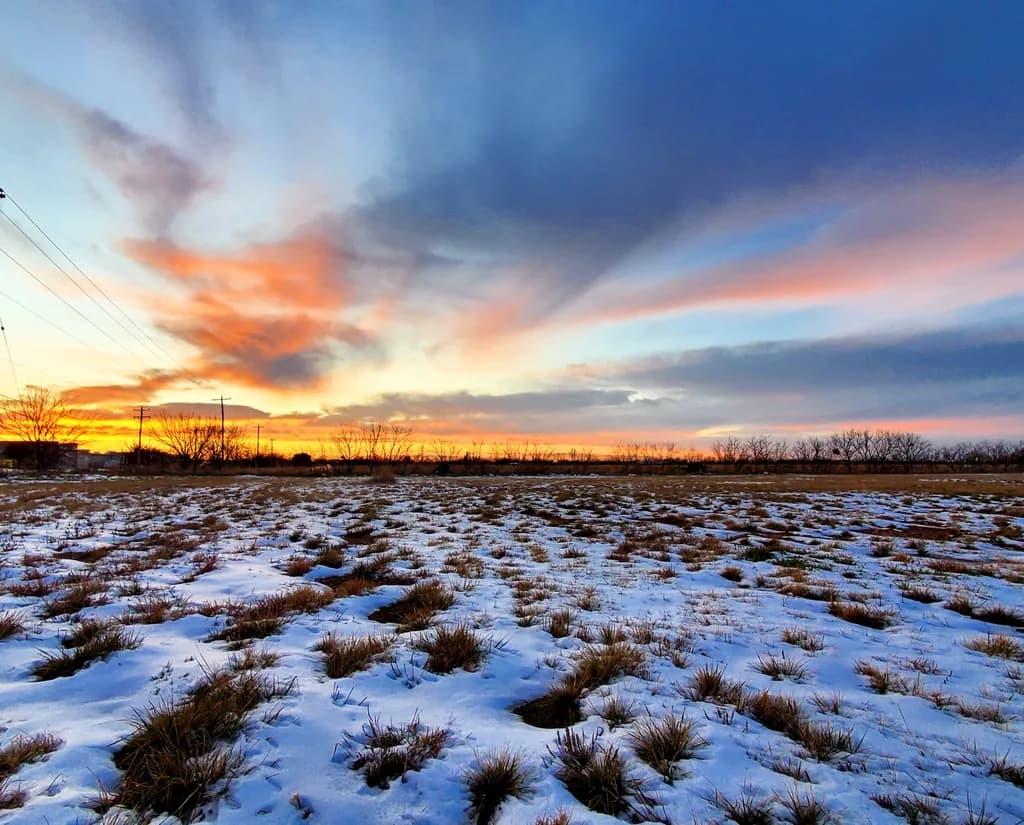 Whispers of a Winter Sunset: A Tranquil Landscape of Snow and Sky