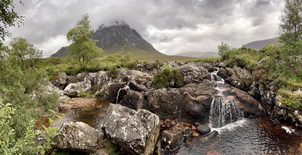 Whispers of the Highlands: A Serene Mountain Stream Amidst the Misty Peaks