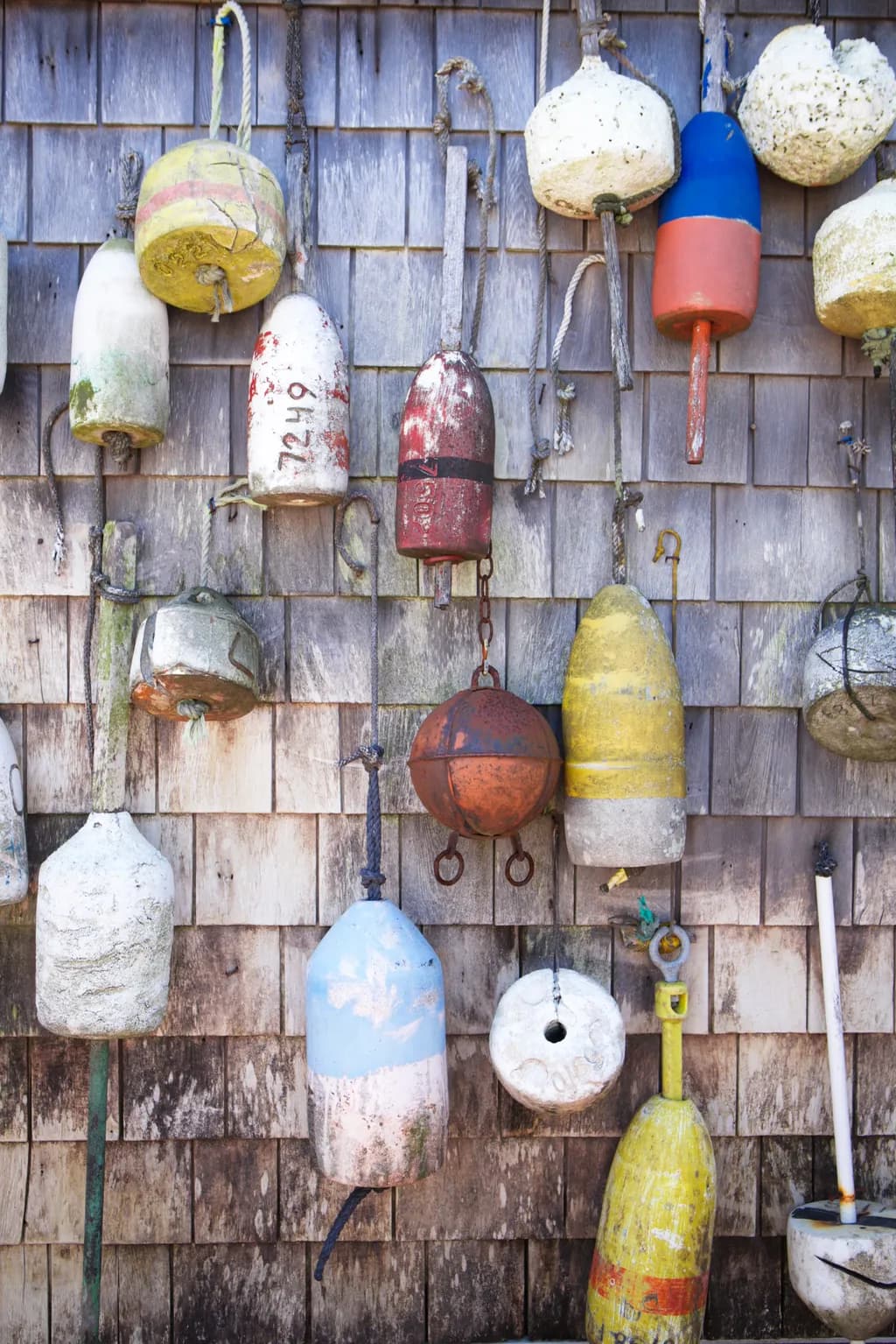 Weathered Nautical Buoys: A Colorful Tribute to Coastal Charm and Texture