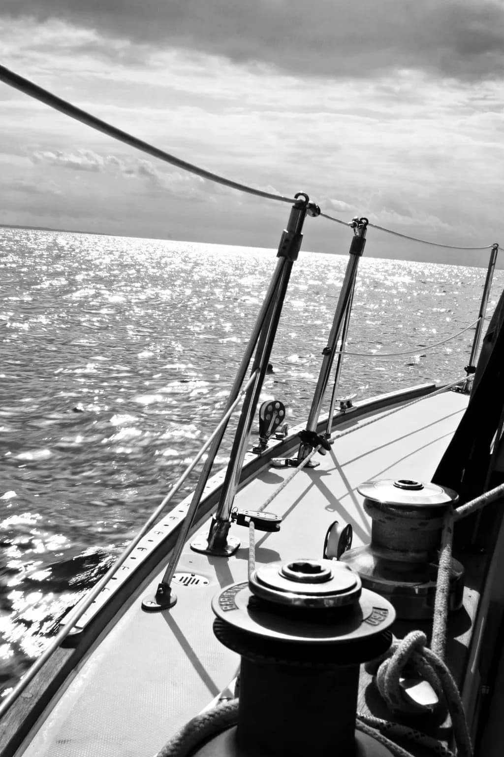 Sailing Serenity: A Black and White Journey Across the Shimmering Sea