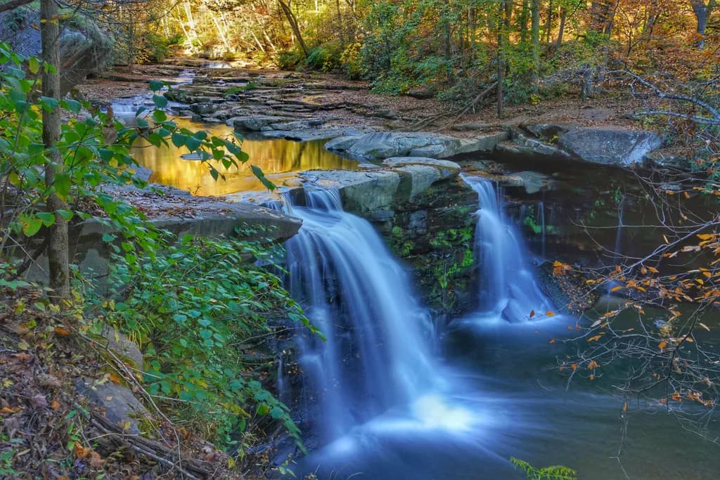 Whispers of Autumn: A Tranquil Waterfall in the Heart of the Forest