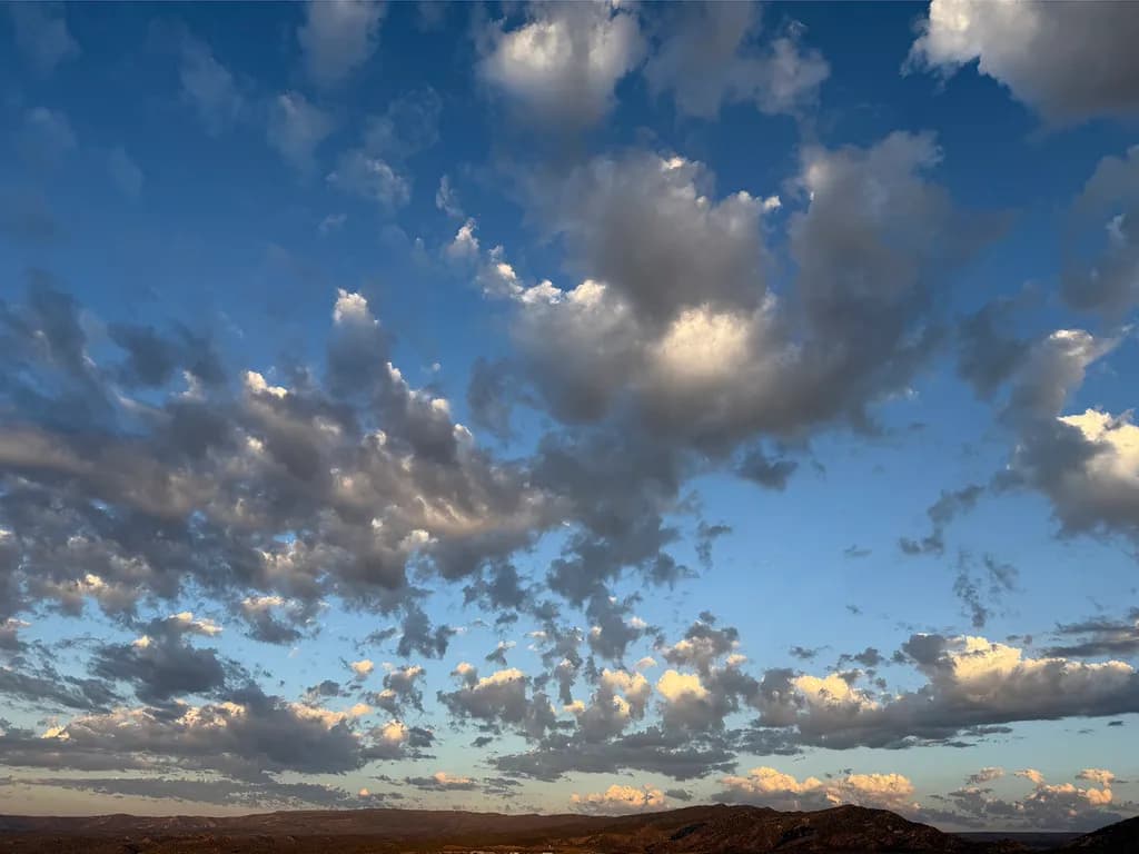 Whispers of the Sky: A Dance of Clouds at Dusk