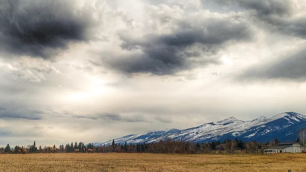 Whispers of the Mountains: A Serene Landscape Under Dramatic Skies