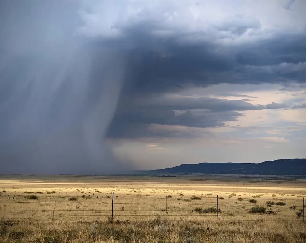 Stormy Horizons: A Dramatic Landscape of Clouds and Fields