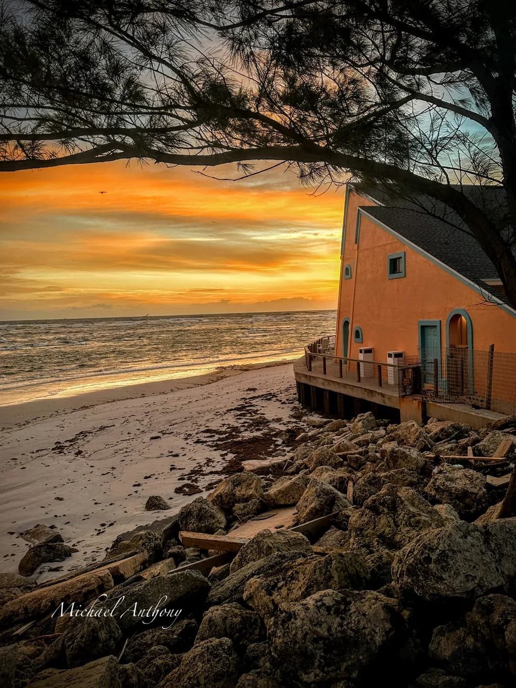 Serenity at Sunset: A Tranquil Beachscape with Ocean and Architecture