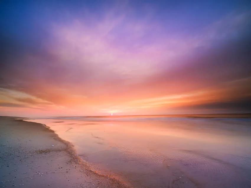 Whispers of Dawn: A Serene Beach Sunrise in Pastel Hues