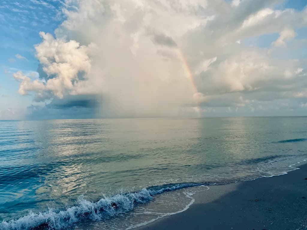 Whispers of the Ocean: A Serene Dance of Clouds and Rainbows