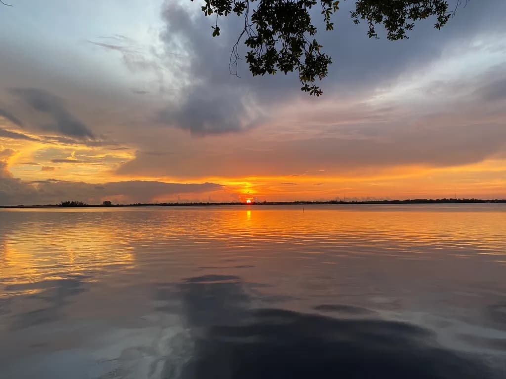 Serene Sunset Reflections: A Tranquil Landscape of Water and Clouds