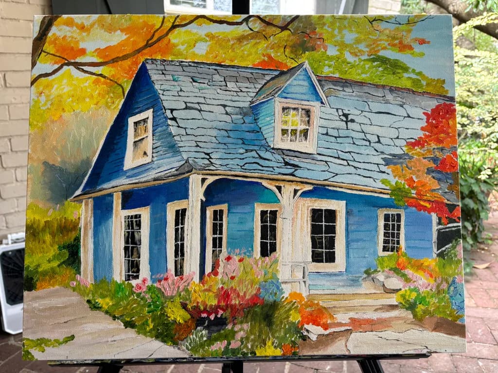 Charming Blue Cottage Surrounded by Vibrant Autumn Blooms