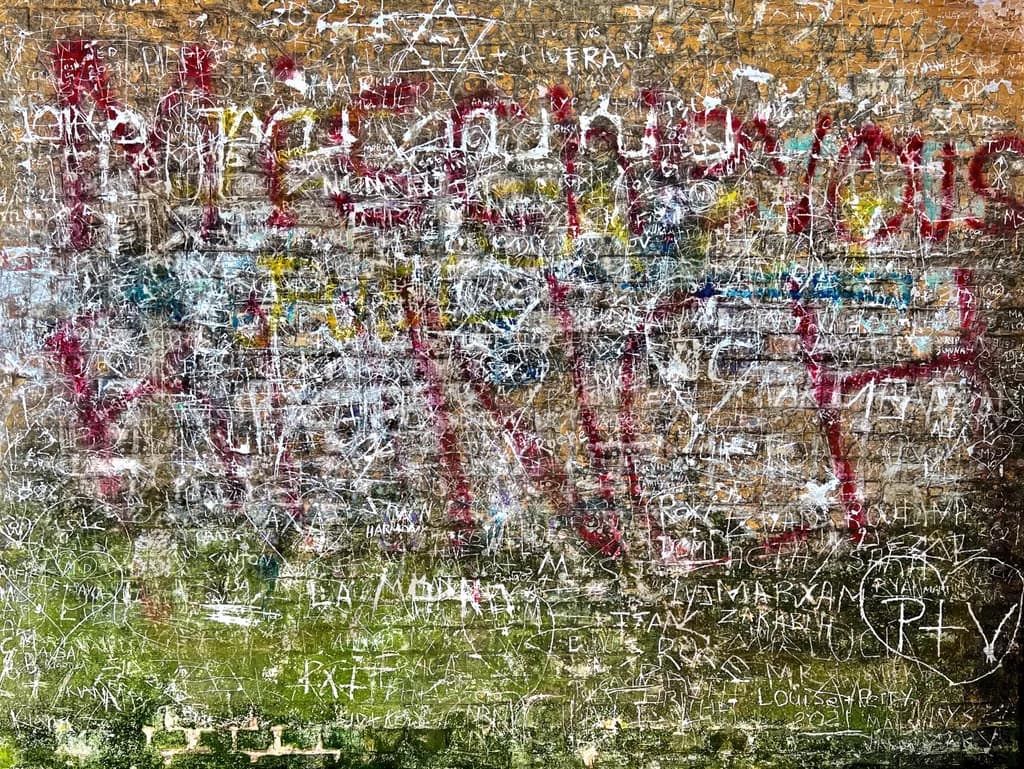 Urban Whispers: A Tapestry of Graffiti and Texture on City Walls
