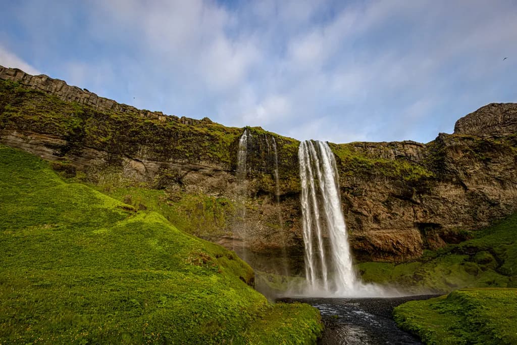 Whispers of Water: The Majestic Seljalandsfoss Falls in Iceland's Lush Embrace