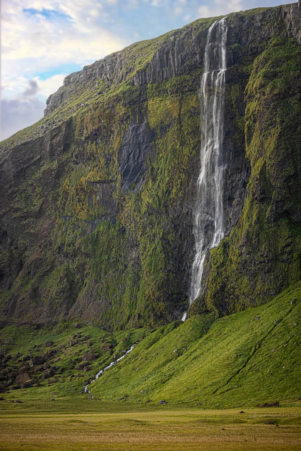 Majestic Cascade: Nature's Symphony in Greenery and Waterfall Splendor