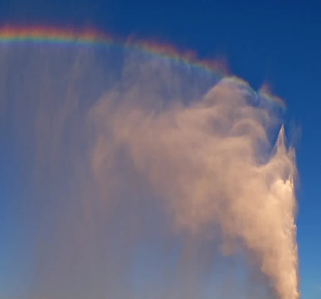 Whispers of Color: A Celestial Dance of Clouds and Rainbows