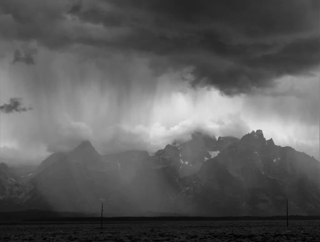 Whispers of Storm: A Monochrome Dance of Mountains and Clouds