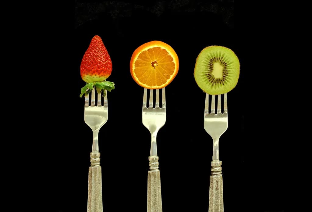 Fruit Symphony: A Colorful Trio of Nature's Delights on Forks
