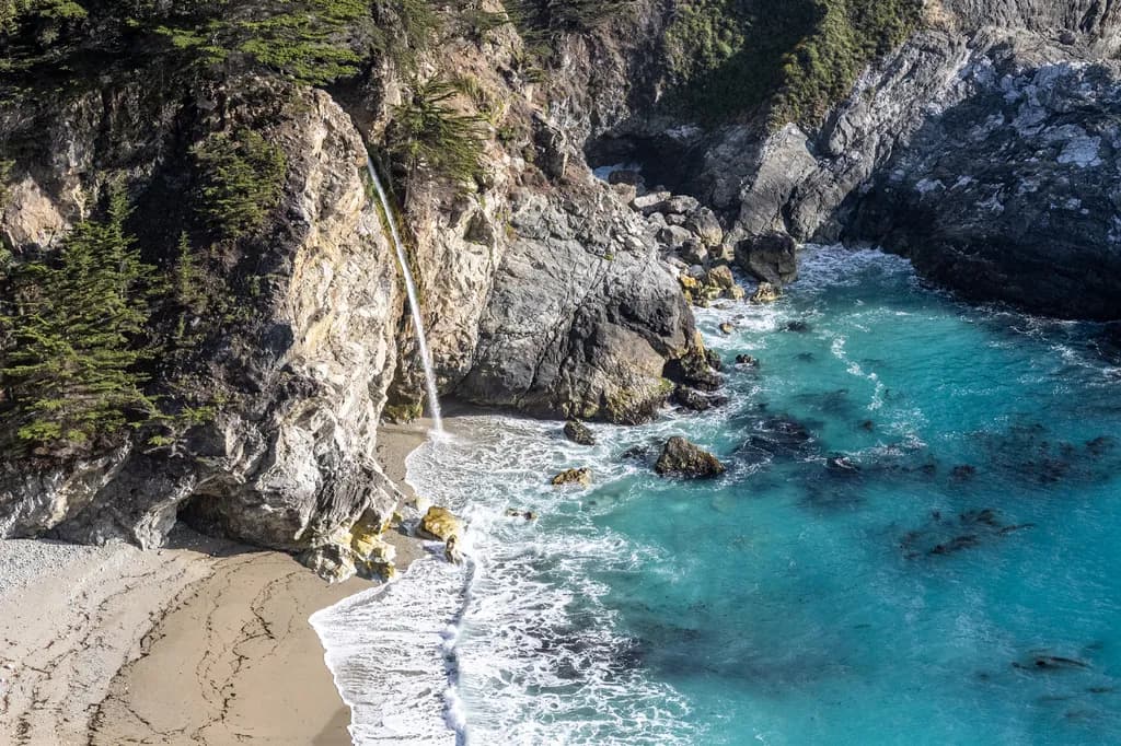 Serenity by the Shore: A Coastal Waterfall's Embrace of the Ocean's Depths