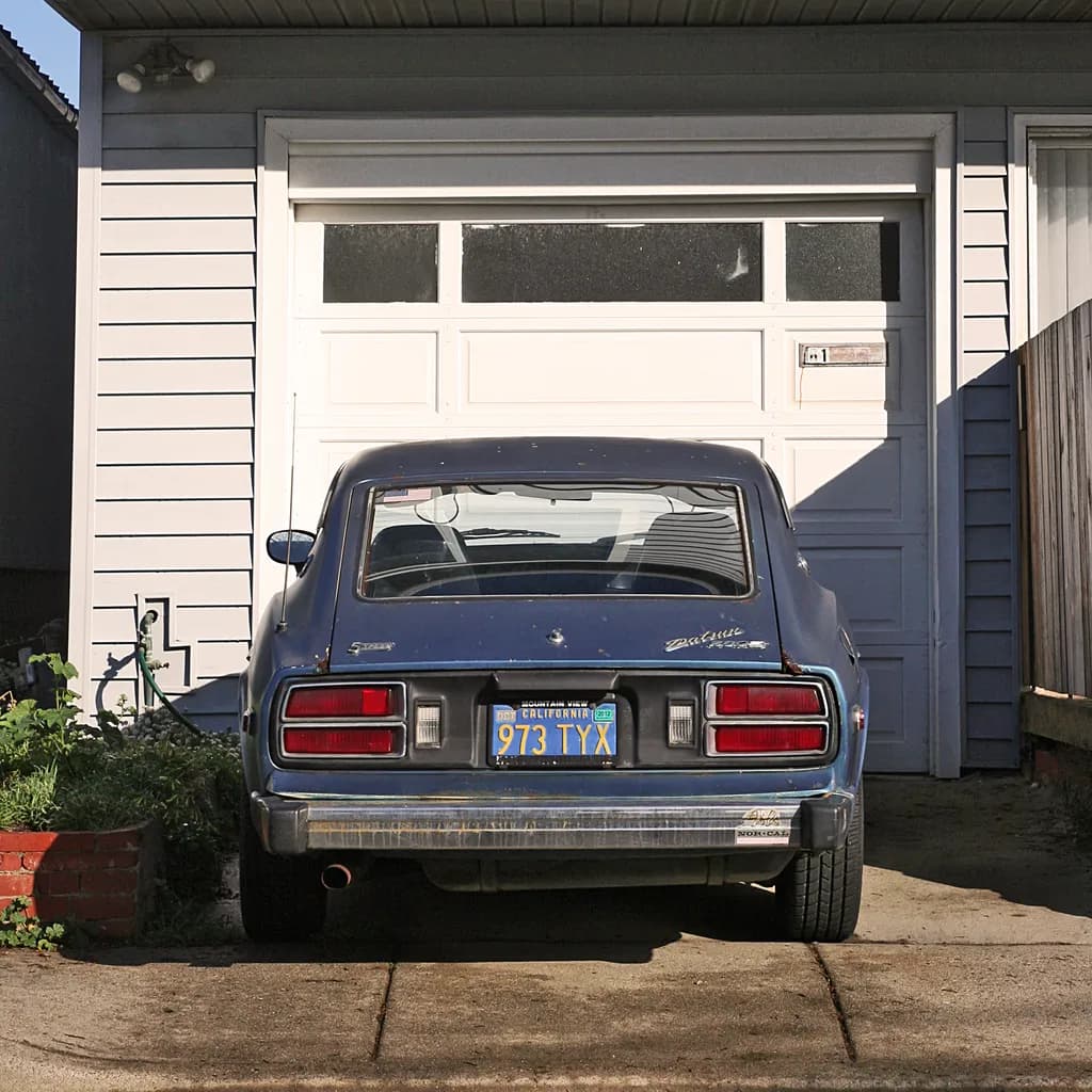Vintage Blue Beauty: A Nostalgic Glimpse of Classic Americana in a Quiet Driveway Scene