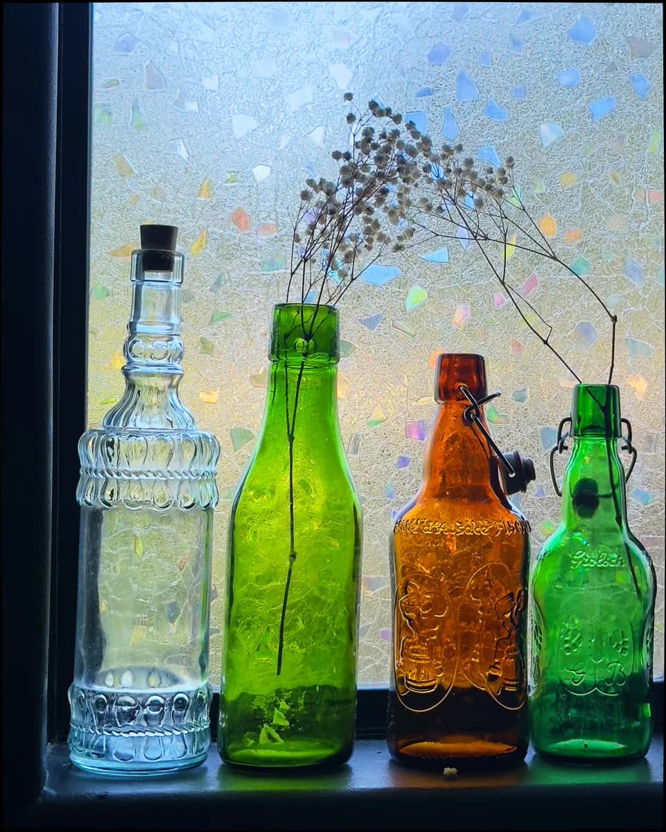 Bottled Whimsy: A Colorful Collection of Vintage Vessels in Natural Light