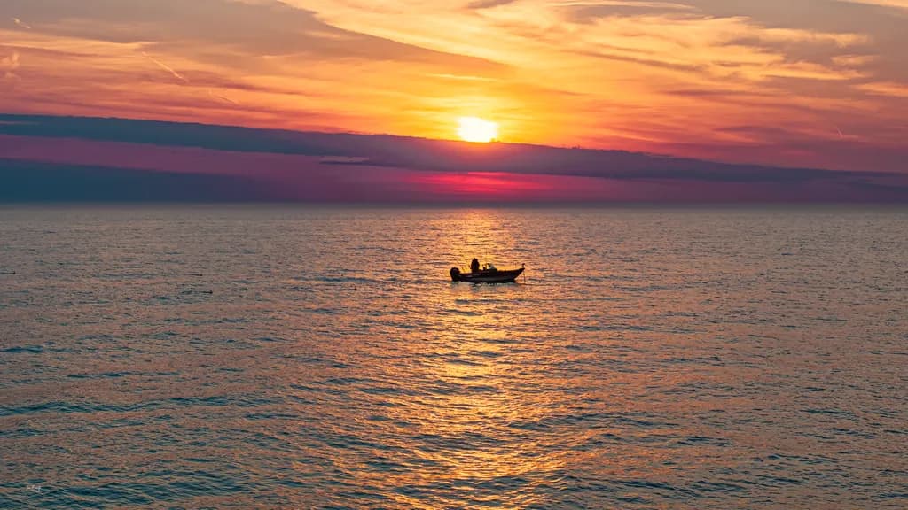 Serenity at Dusk: A Fisherman's Journey into the Golden Horizon