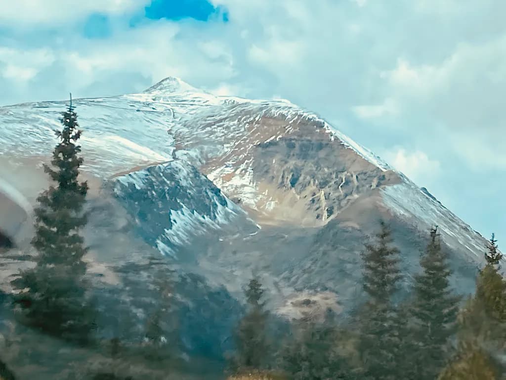 Whispers of the Mountain: A Journey Through Snow-Capped Peaks and Pine-Laden Trails